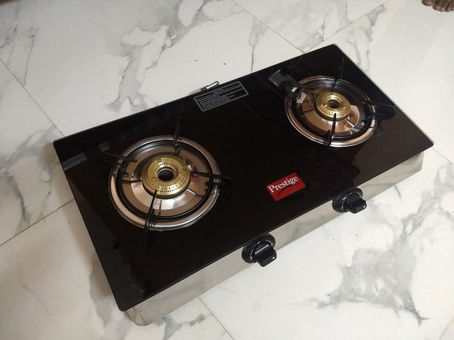 Two unlit gas stove burners with visible circular burner openings