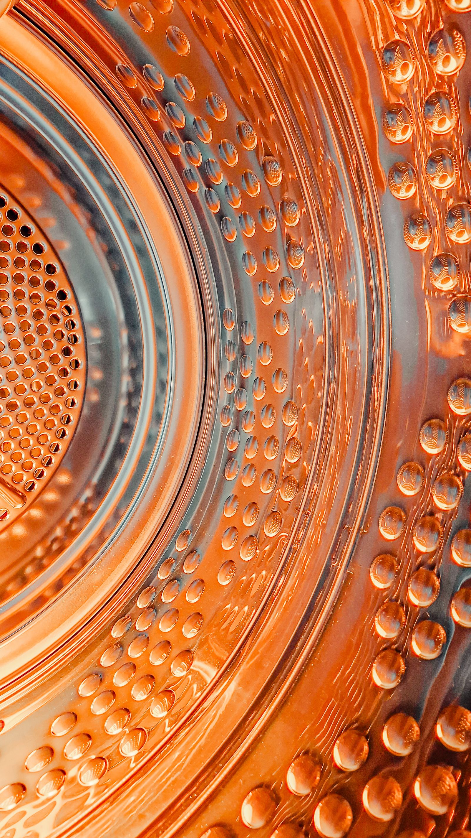 Close view of laundry machine drum texture for hidden lint buildup checks
