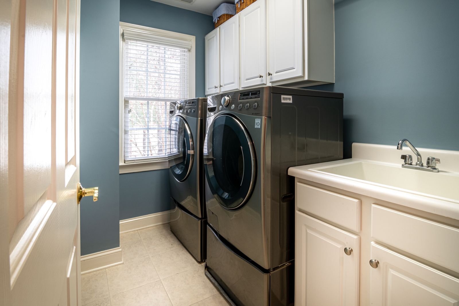 Modern laundry room with black washer and dryer for laundry area maintenance
