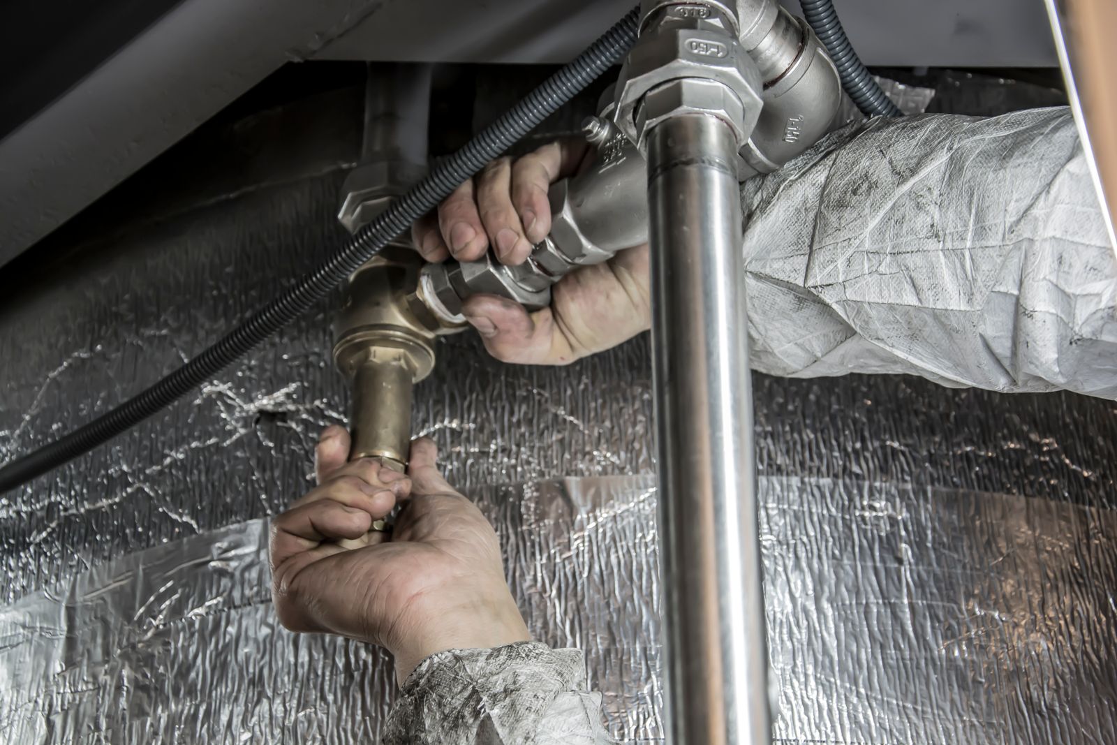 Tight under sink plumbing gap showing deep clean maintenance problem