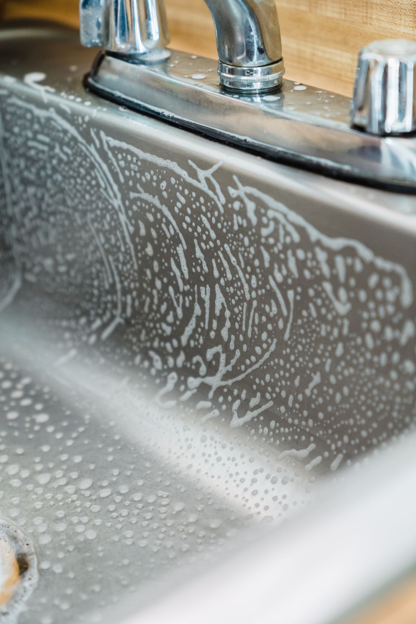 Foamy sink cleaning scene for routine home deep clean with tablets